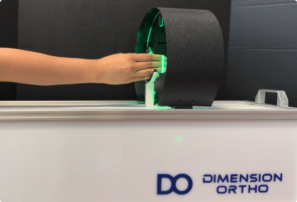 hand entering a 3D scanner